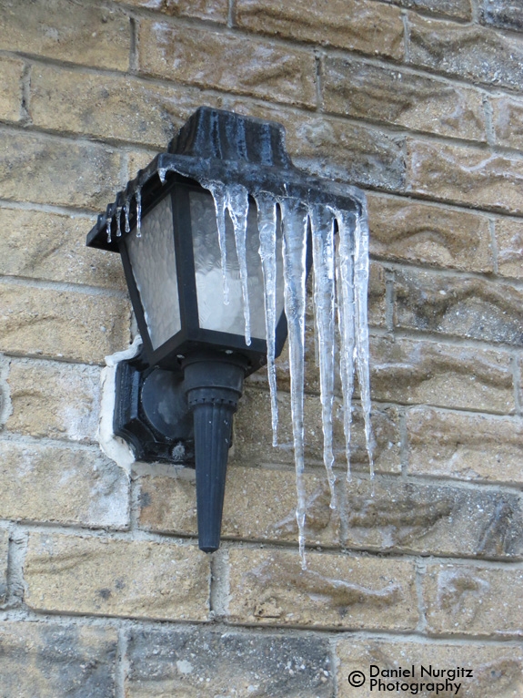 Icicles hanging off an outdoor lamp