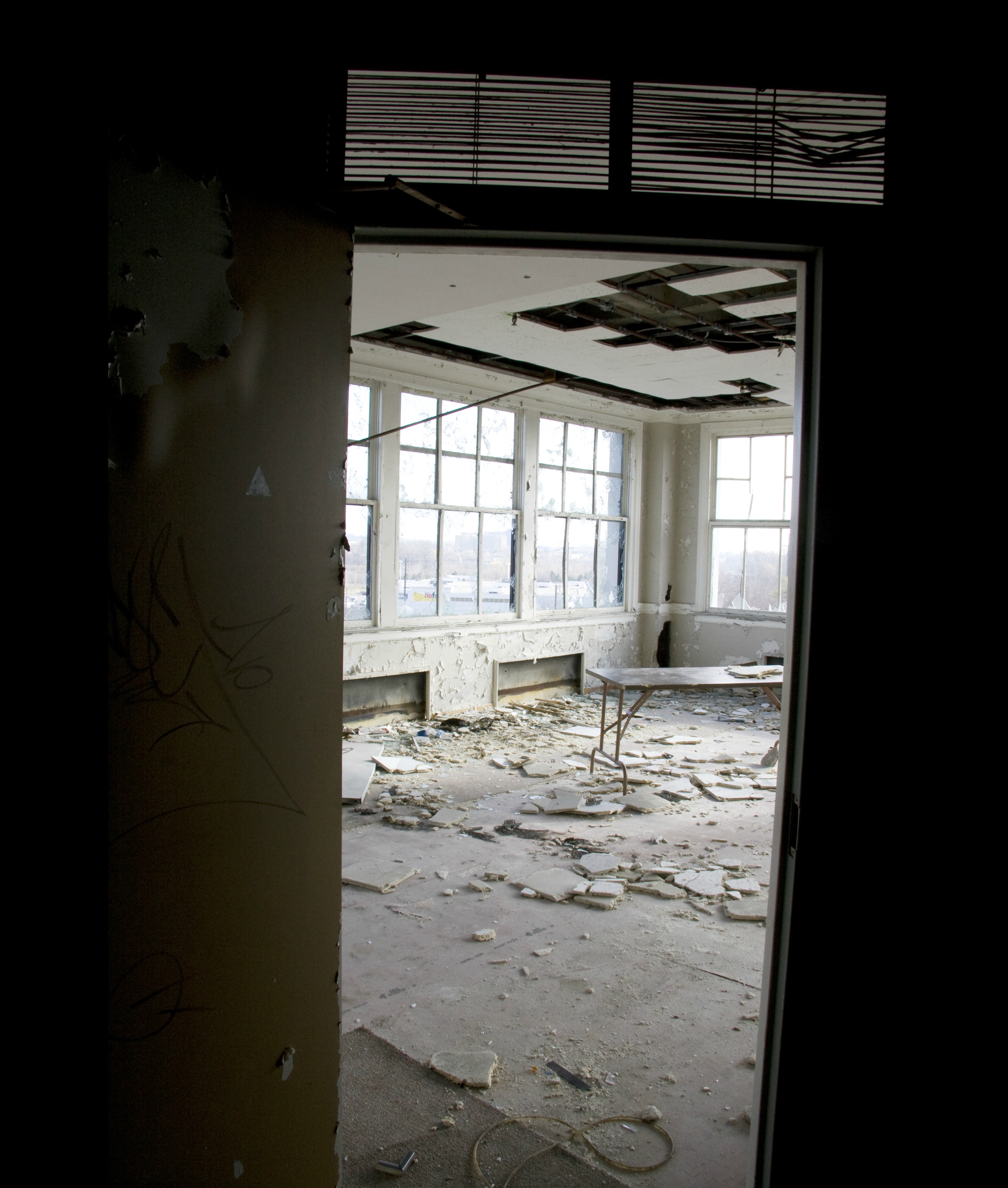 VIEW TO THE ROOM - after emerging from the darkness, colours began to show. Yellowed, peeling paint, dusty white debris from crumbling ceiling tiles and flashing fragments of glass painted a dreary picture of the building's interior.
